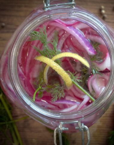 Final Pickling image in jar with lemon peel and dill.
