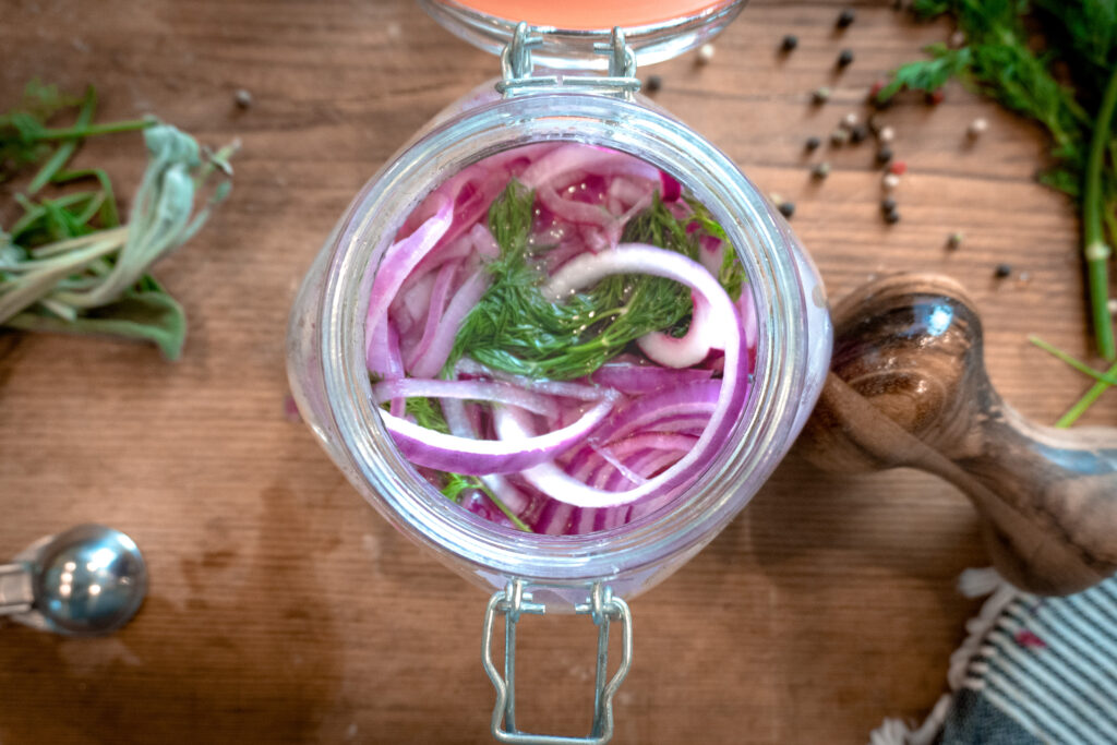 Easy - Delicious Pickled Red Onion Recipe 5.  Open glass jar with pickled onion in it.